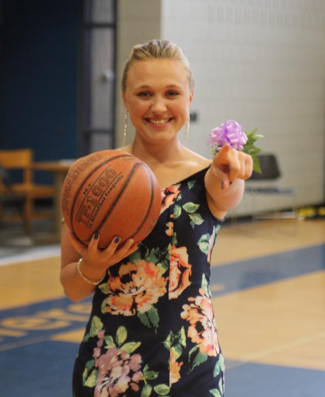 Madison Pinkston, a member of the girls basketball team, poses in the gym before leaving for the prom. BY MATTHEW BERNAT